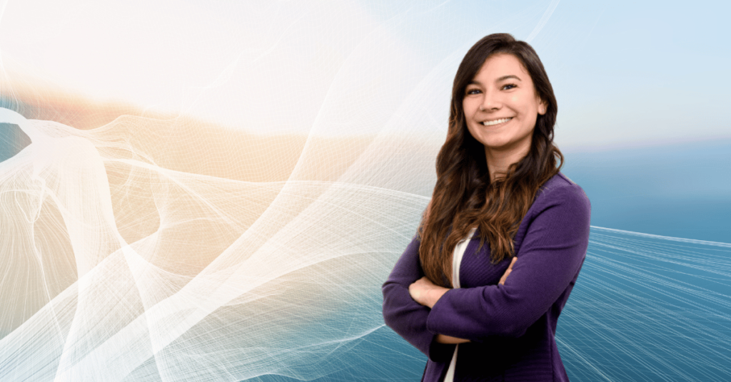 Young woman in a purple blazer smiling with her arms crossed in front of a futuristic background